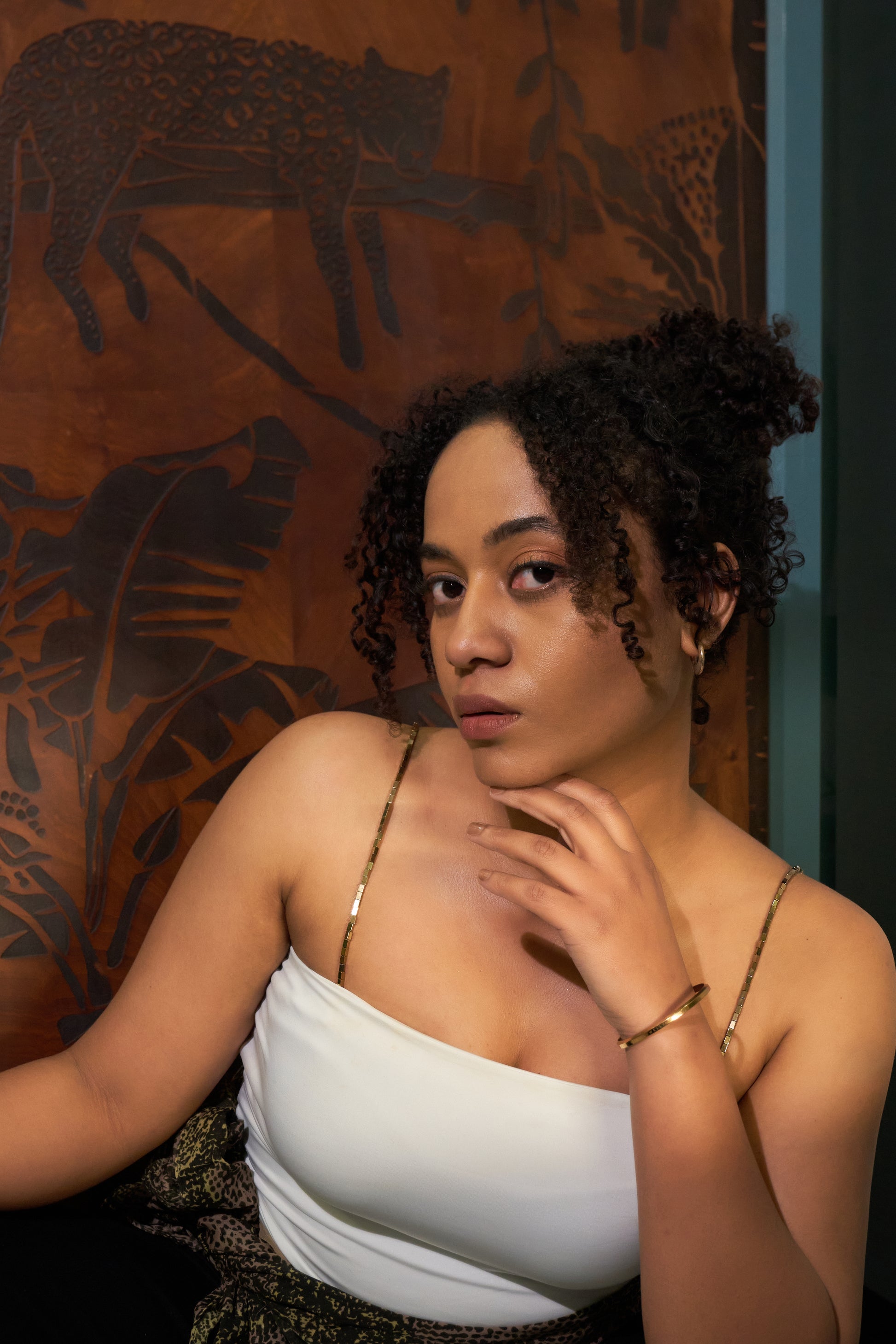 Model wearing a sleek gold chain shoulder accessory styled as a bra strap replacement for sleeveless, spaghetti-strap and strapless-look outfits.