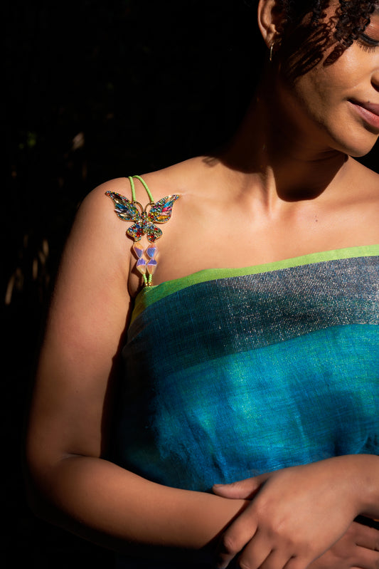 a model styling her shoulders with THE RAMP RUSH luxury and premium wild butterfly shoulder straps