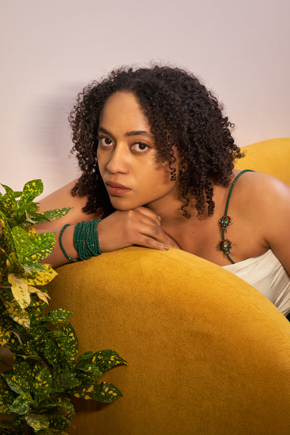 Emerald beetle beaded bra straps styled as a luxury shoulder accessory on model, featuring designer brooch detailing by The Ramp Rush