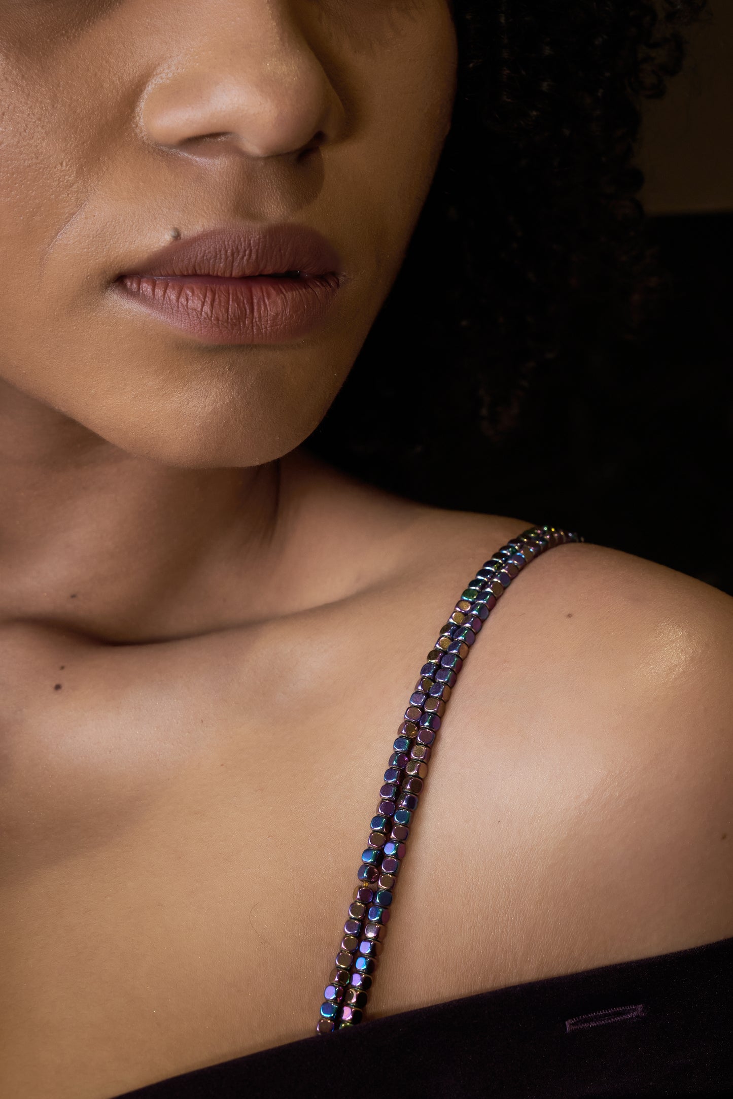 close up look of the rainbow beaded bra straps which is styled by the model so casually.