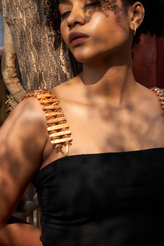 Honey Luxe shoulder accessory styled on model, premium lingerie accessory with bold orange beaded design